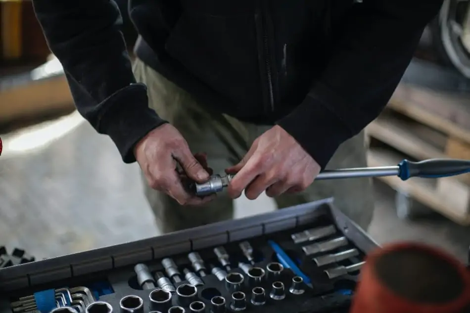 A man fixing something. 