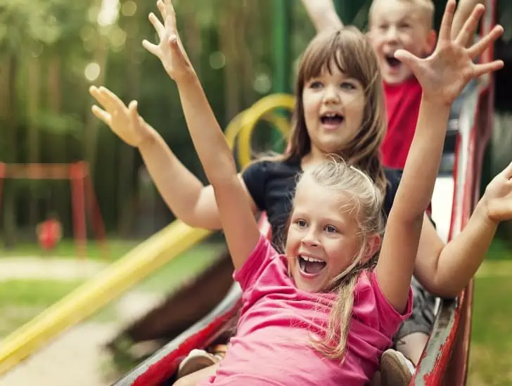 Kids having fun on a slide. 